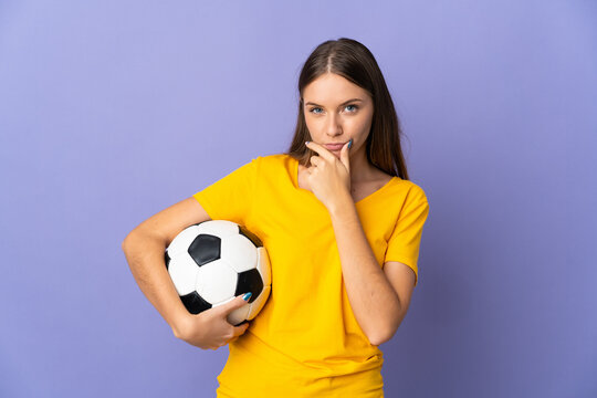 Young Lithuanian football player woman isolated on purple background thinking