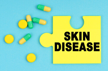 On a blue background, there are pills and a puzzle with the inscription - SKIN DISEASE