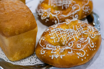 Freshly baked breads, pretzels, kringles on plate at cuisine of cafe, restaurant or bakery. Pastry, pastry, culinary, gastronomy and food concept