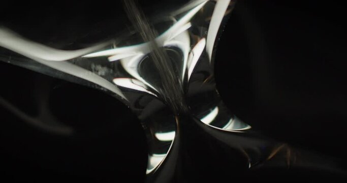 Macro shot of hourglass rotating, while sand moves inside and smoke surrounds it on a black background. Running time abstract concept. 
