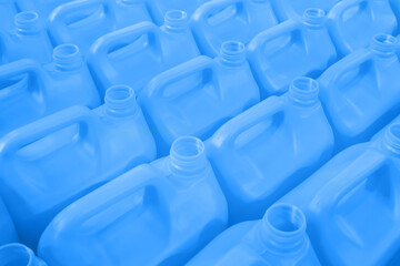 Many empty blue plastic jerrycans background in warehouse, market, factory or exhibition