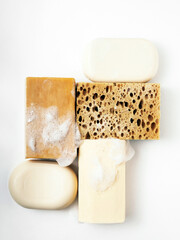 pieces of soap and a sponge in soap on a white background