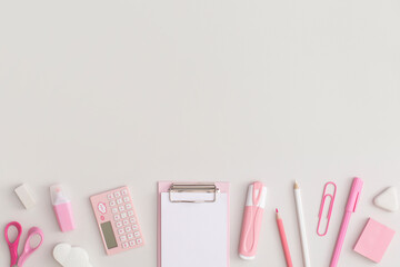 Pink school stationery on a grey background. Top view. Flat lay. Back to school concept.