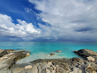 Fototapeta na wymiar Crystal clear water amidst rocks and sandy beaches of North Bimini's west coast in Bahamas.