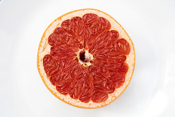 red grapefruit cut in half, still life, studio photography, fruit on a white background