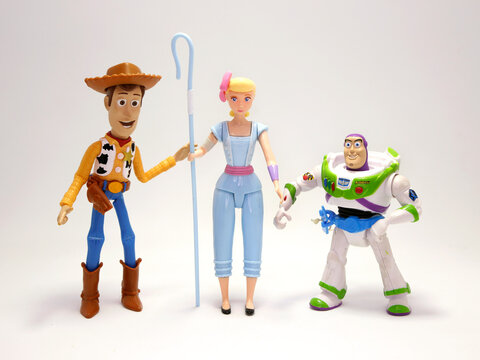 Toy Story movie. Woody,  Bo Peep and Buzz Lightyear. Pixar and Disney movie toys. Cowboy,  shepherd and astronaut. Porcelain doll of a night lamp. . I will be your faithful friend. Isolated white. 