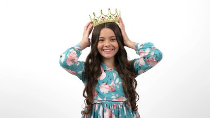 happy egocentric child in queen crown pointing thumb up on herself, egoistic