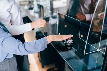 Young couple at the reception of a hotel checking in.