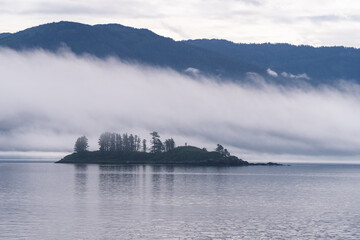 Naklejka na ściany i meble Island in sea with fog