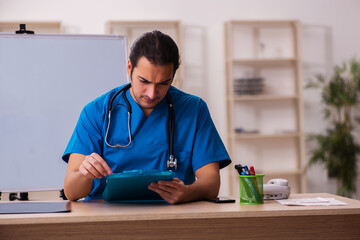 Young male doctor working in the clinic