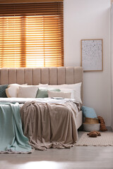 Stylish room interior with big comfortable bed