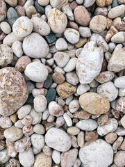large, medium, small stones of different colors green, yellow, brown, white