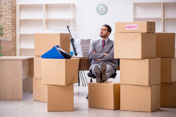 Fototapeta premium Young male employee in relocation concept