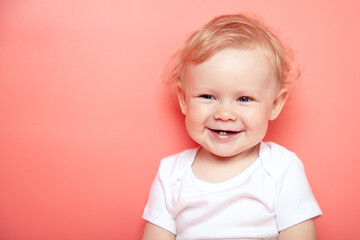 portrait caucasian curly blond smiling baby girl with two teethon pink background wearing in white t-shirt. copy space. - obrazy, fototapety, plakaty