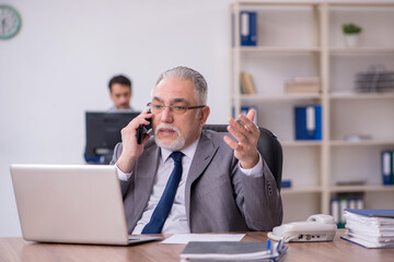 Two male employees working in the office