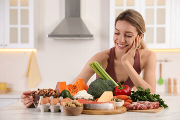 Woman with healthy food in kitchen. Keto diet