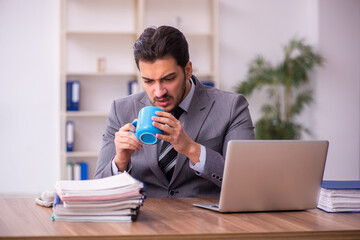 Young businessman employee having break at workplace