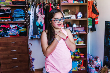 portrait of latin girl teenager with Down syndrome dancing in home in disabled people concept in Latin America	
