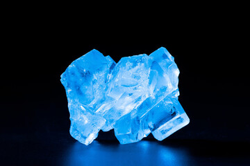 blue crystal stone closeup isolated on black background