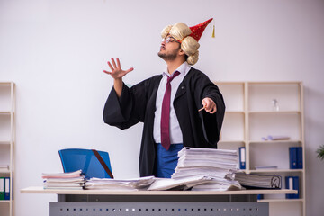 Funny young male employee magician and too much work in the office