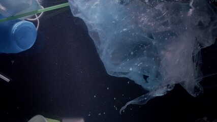 Garbage in water against dark background. Ecology concept - Powered by Adobe