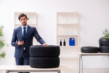 Young man selling tires in the office