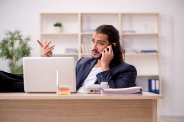Young male employee working in the office