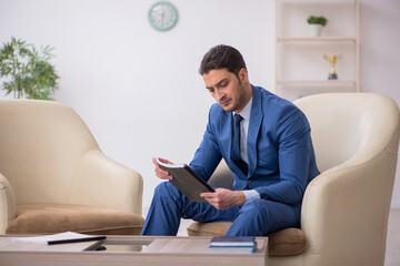 Young male employee waiting for business meeting