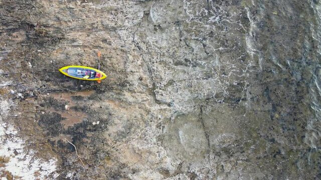 Kayak and paddle on shore, waves washing on rocky beach, Dugi Otok, Croatia