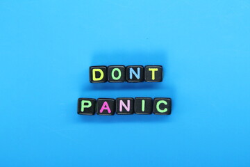 small black cubes with the word don't panic are colored