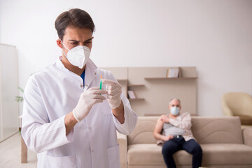 Young male doctor visiting old patient in vaccination concept