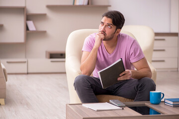 Fototapeta premium Young male employee at home during pandemic