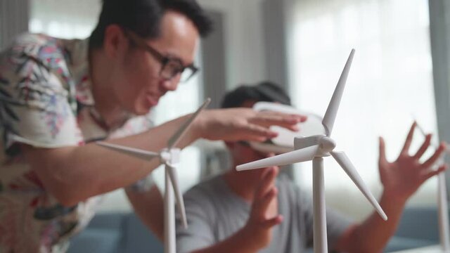 Wind Turbine Model And Blur Teacher Teaching Boy While Wearing Vr Glasses
