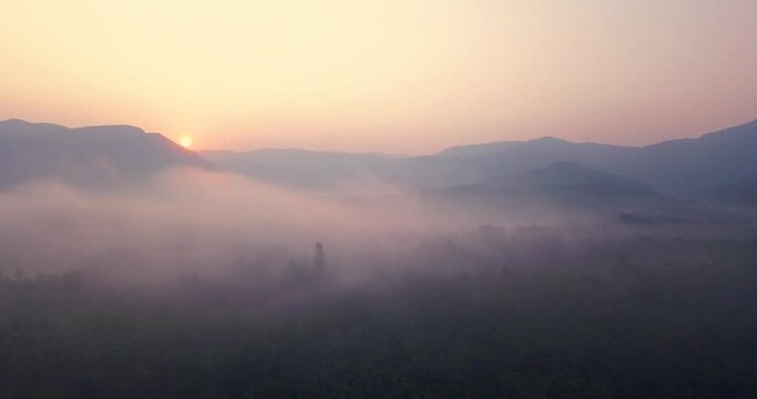 Fiery Sunset Over Mountain Forest With Beautiful Misty Clouds At Cotigao Wildlife Sanctuary In South Goa, India. - Aerial Wide Shot