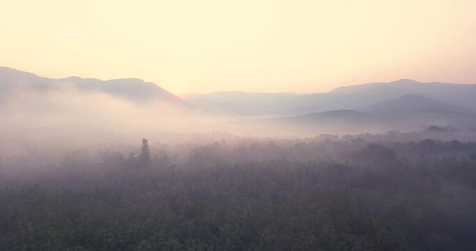 Vivid Clouds Rolling Over Mountains With Shaggy Jungle During Foggy Morning At Cotigao Wildlife Sanctuary Netravali In South Goa, India. - Aerial Wide Shot