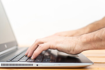 Hands typing on a Laptop with blurred background