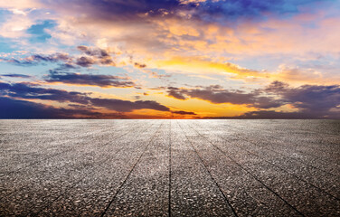 Asphalt floor extends lines and beautiful sunset skyline.