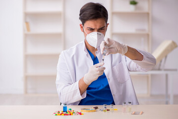 Young male doctor in vaccination concept