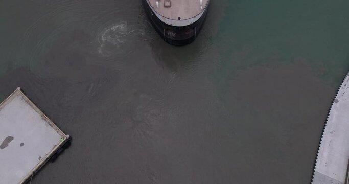 Aerial Reveal Of A Bulk Carrier Departing From Kingsville Harbour. MV Sam Laud In Ontario, Canada. tilt-up