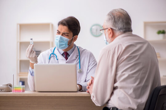 Old male patient visiting young male doctor in vaccination conce