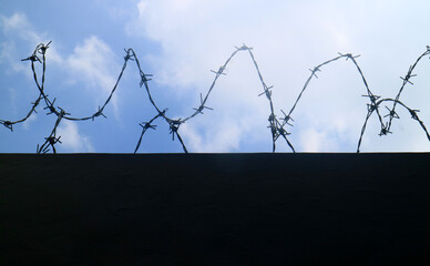 Barbed wire over the walls of the building.