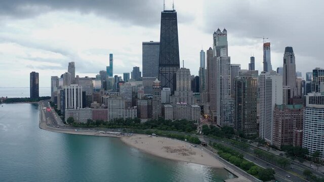Slow aerial push in over Chicago's oak street beach with skyline in background