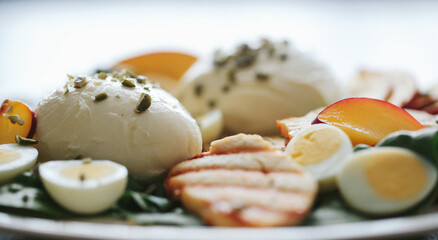 Healthy vegetable salad of fresh tomato, cucumber, onion, spinach,eggs, lettuce and sesame on plate.