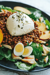 Healthy vegetable salad of fresh tomato, cucumber, onion, spinach,eggs, lettuce and sesame on plate.