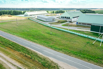 aerial view of farm buildings and farmland in countryside. rural summer landscape.