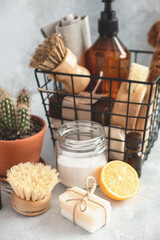 Wooden bamboo brushes, baking soda, lemon, essential oils, vinegar, natural soap. Zero waste eco friendly cleaning concept. Soft focus. Vertical photo