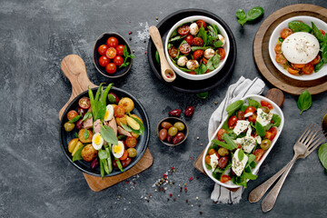 Assorted salads on dark gray background. Seasonal food concept.