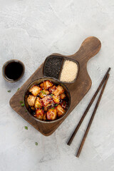 Traditional homemade fried tofu with sesame on light gray background.