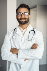 Portrait of indian man doctor medic professional standing with arms crossed