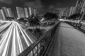 Light trail of traffic on highway and pedestrian walkway in Hong Kong city at night